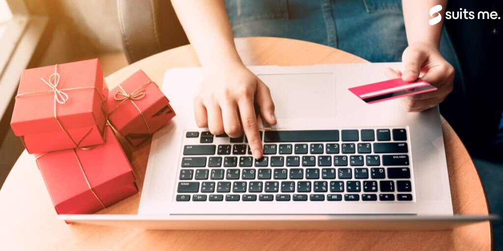 woman using a laptop and typing in visa or mastercard card number for buying gifts